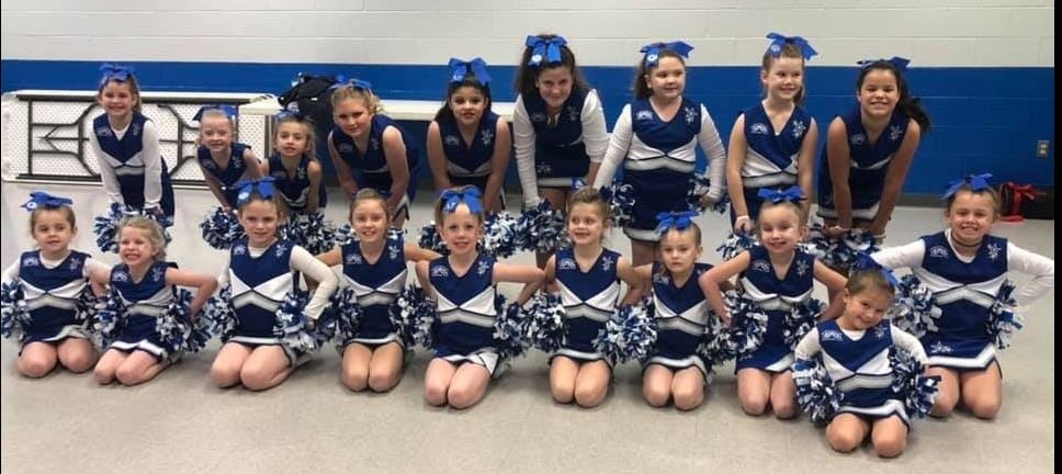 Group of cheerleaders ages 4-12 in blue and silver